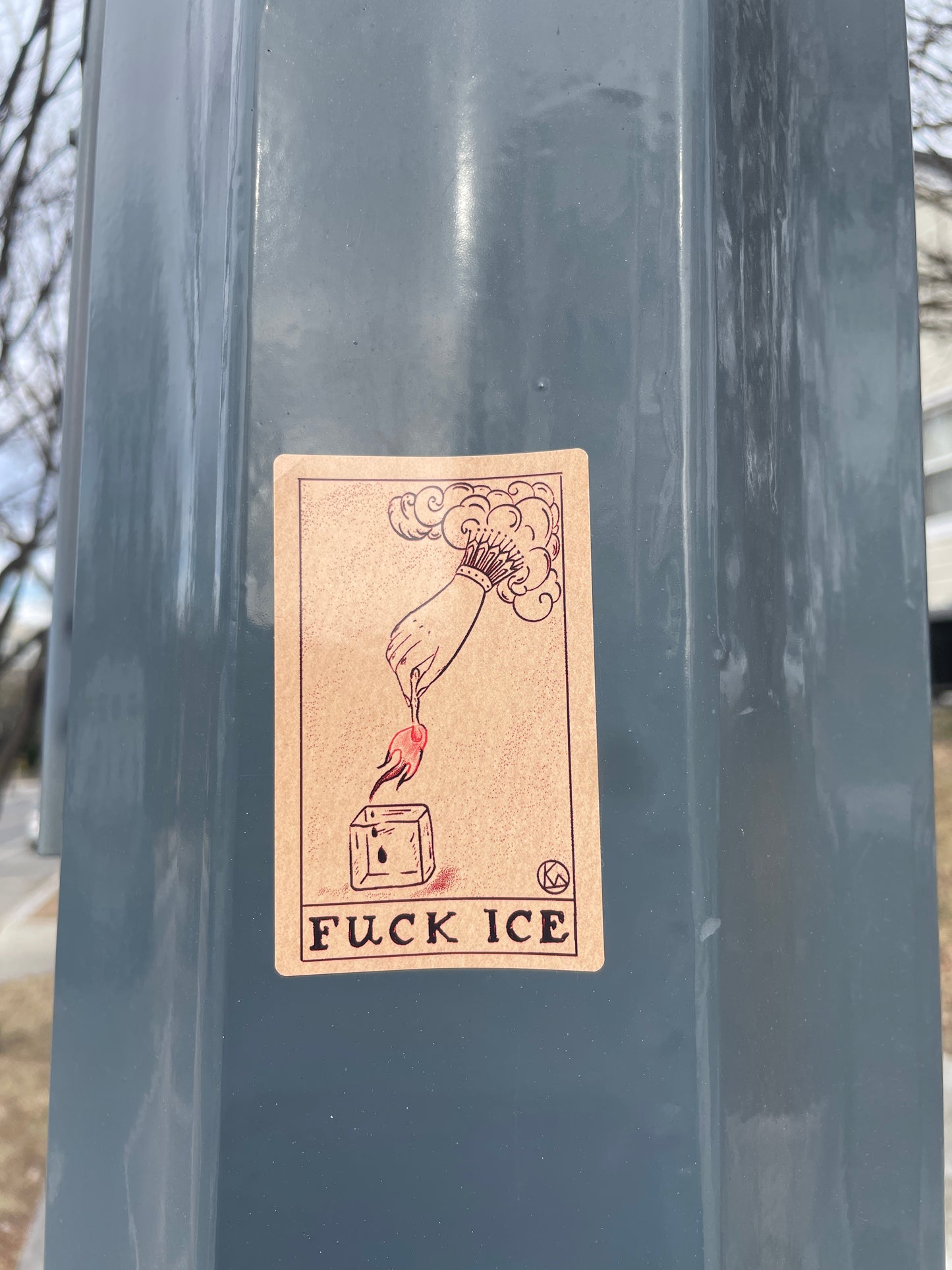 Sticker with graphic design and text on a metallic surface